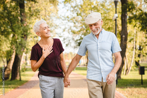 Wallpaper Mural Romantic mature man and woman drinking coffee to go walking together on summer park. Happy loving senior couple embracing smiling to each other, older spouses enjoying outdoor date, copy space Torontodigital.ca