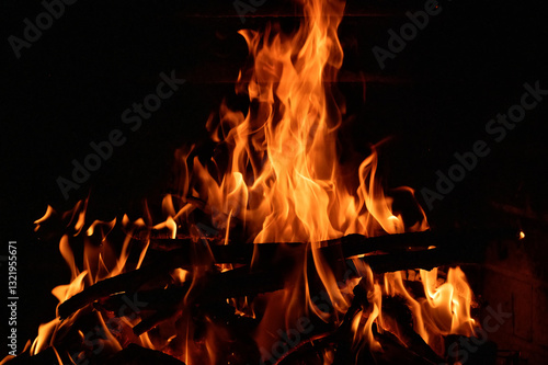 Obraz na płótnie a fire burning in the dark at fireplace w salonie