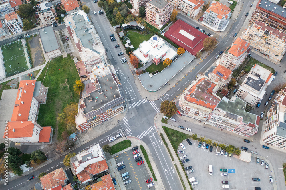 Aerial view from drone of a city road junction and car parking