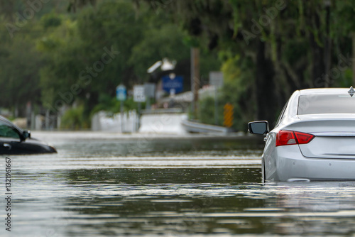 Flooded road with sunken cars in surrounded with water Florida residential area. Consequences of hurricane Debby natural disaster