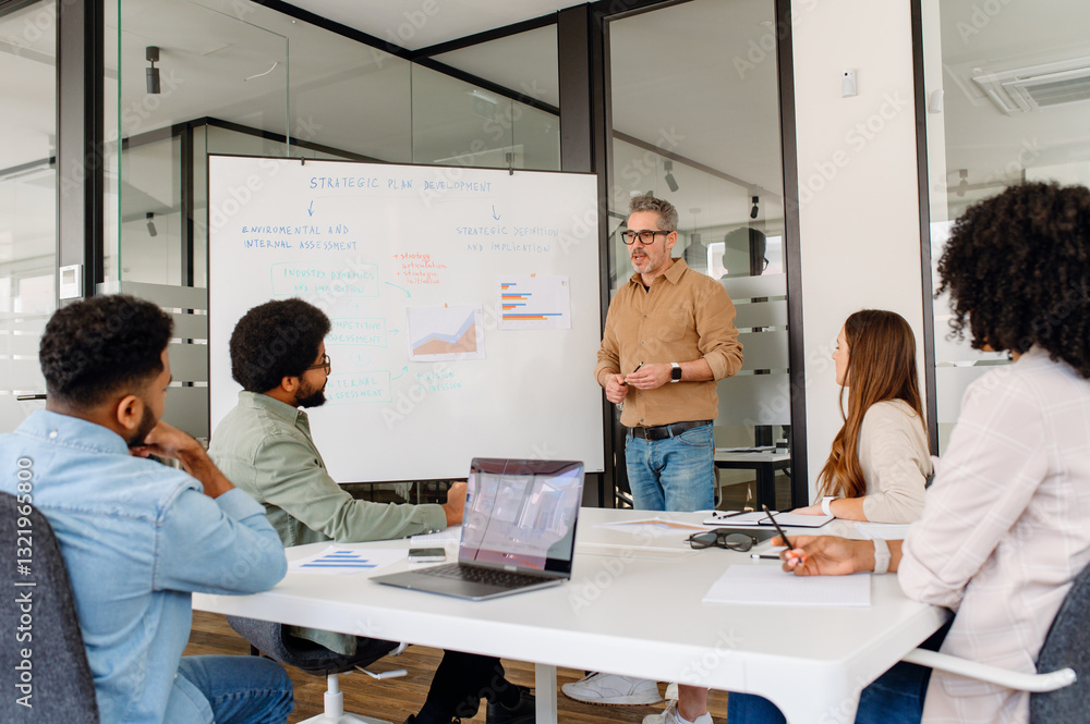 Business executive leading a strategic presentation in modern office.Team members actively listening, engaged in corporate planning, market analysis, and innovative decision-making for company success Business executive leading a strategic presentation in modern office.Team members actively listening, engaged in corporate planning, market analysis, and innovative decision-making for company success
