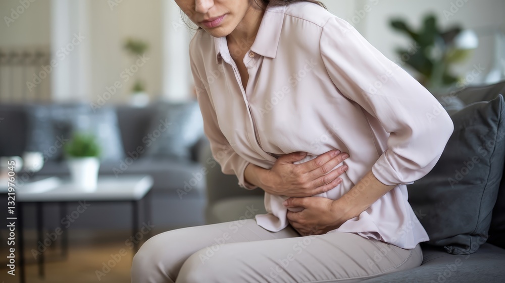 Woman Experiencing Abdominal Pain at Home Woman Experiencing Abdominal Pain at Home