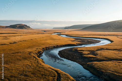 Serene Landscape of Curving River in Vast Golden Plain Under Clear Blue Sky with Gentle Hills in the Background