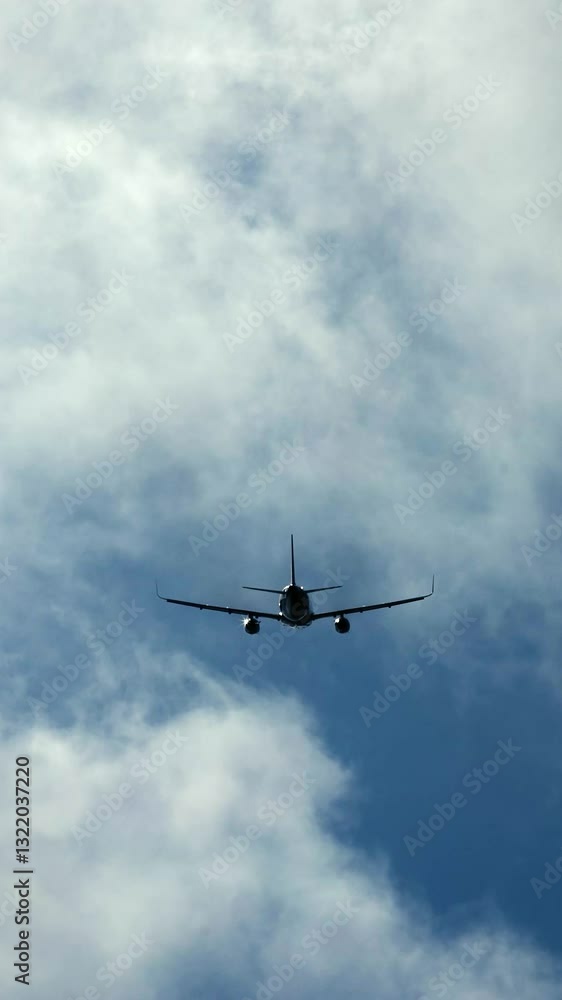 Vertical video. An airplane soars through the sky framed by stunning clouds. This concept illustrates travel and the reliability of air transportation. Vertical video. An airplane soars through the sky framed by stunning clouds. This concept illustrates travel and the reliability of air transportation.