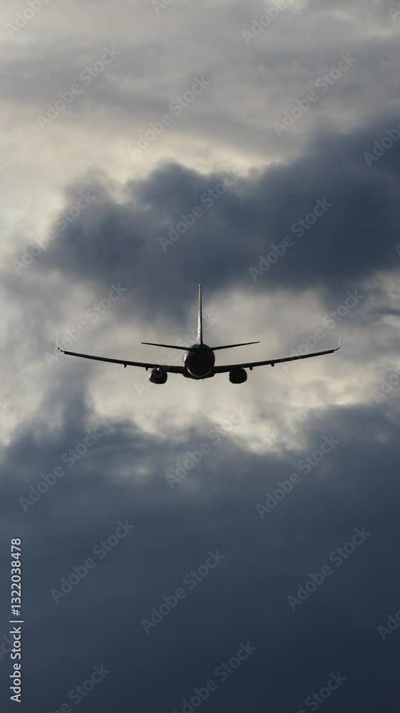 Vertical video. An airplane soars through the sky framed by stunning clouds. This concept illustrates travel and the reliability of air transportation. Vertical video. An airplane soars through the sky framed by stunning clouds. This concept illustrates travel and the reliability of air transportation.