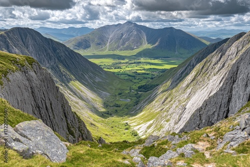 Mountain valley vista, rugged peaks, lush green valley