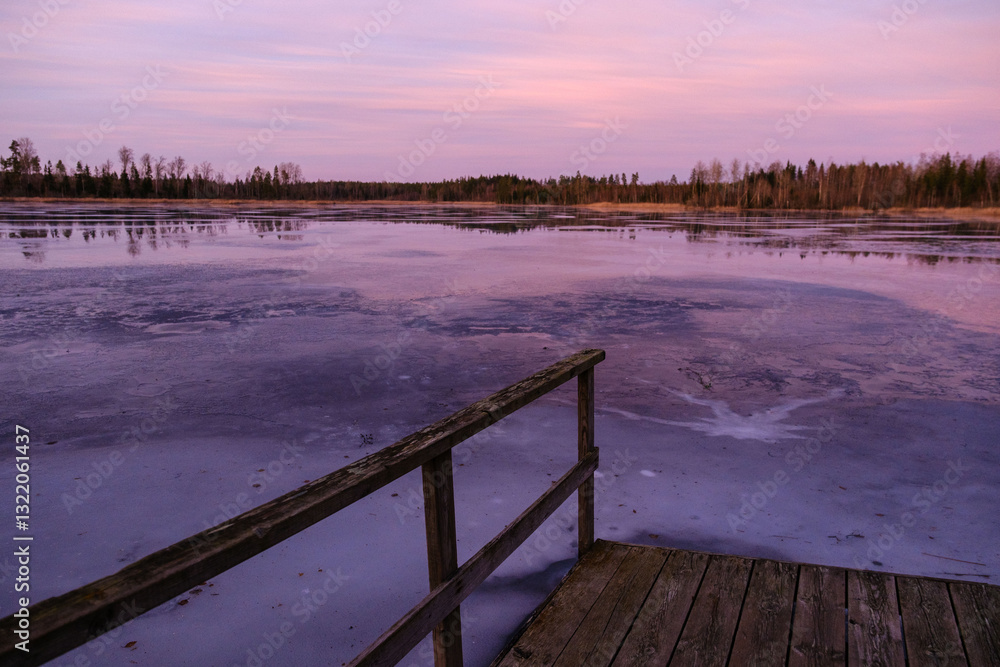 Frozen lake in sunset with a crack