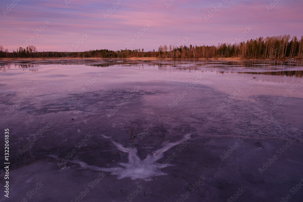 Frozen lake in sunset with a crack
