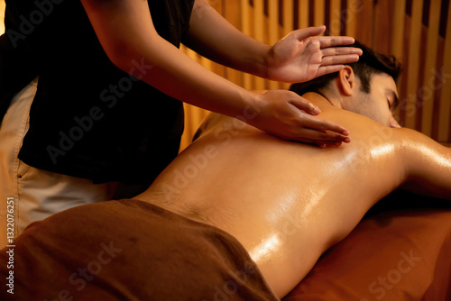 Wallpaper Mural Caucasian man customer enjoying relaxing anti-stress spa massage and pampering with beauty skin recreation leisure in warm candle lighting ambient salon spa at luxury resort or hotel. Quiescent Torontodigital.ca