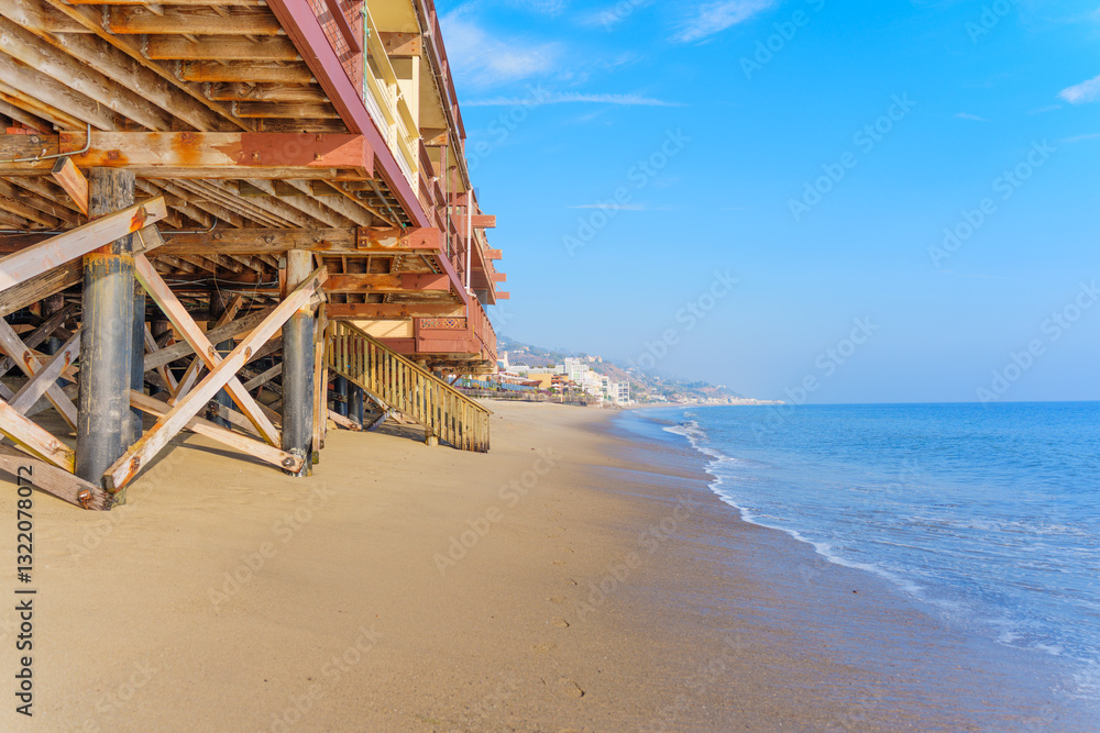 Malibu Beach Pier View with Wooden Supports and Calm Ocean Waves Malibu Beach Pier View with Wooden Supports and Calm Ocean Waves