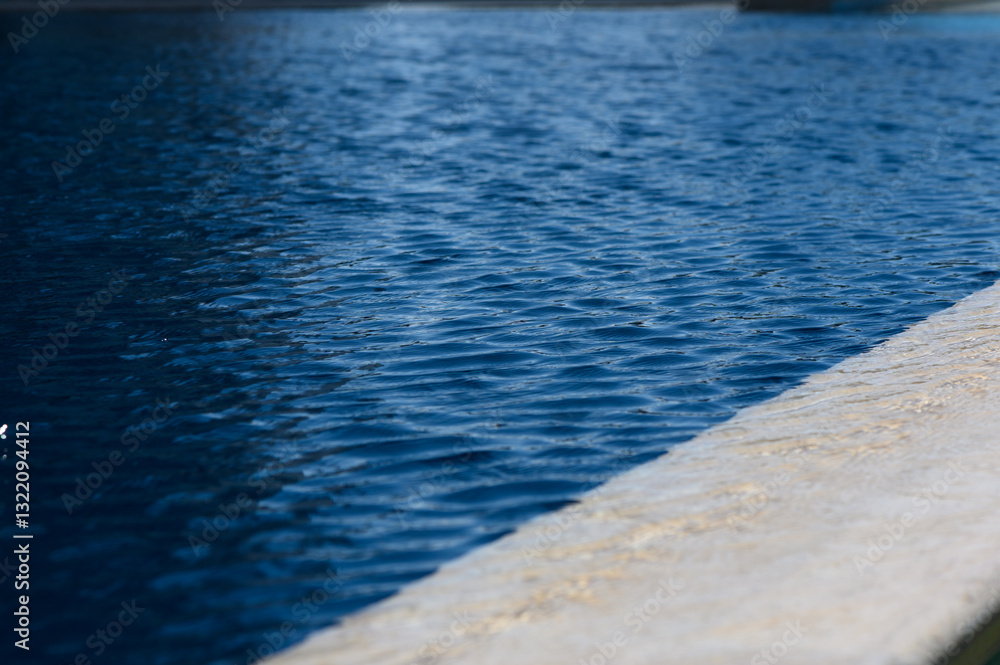 Tranquil water ripples create calming reflections in a serene pool under a clear sky Tranquil water ripples create calming reflections in a serene pool under a clear sky