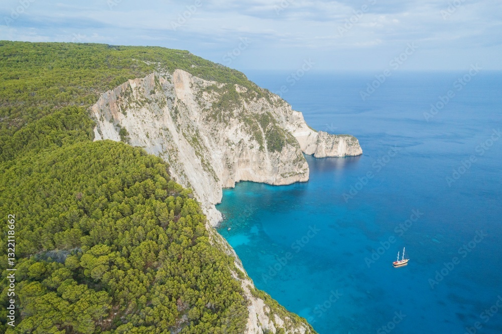 Fototapeta premium Sail through the tranquil Ionian Sea as the sun sets behind Zakynthos, revealing breathtaking views of white cliffs and lush olive groves. Experience serene coastal beauty