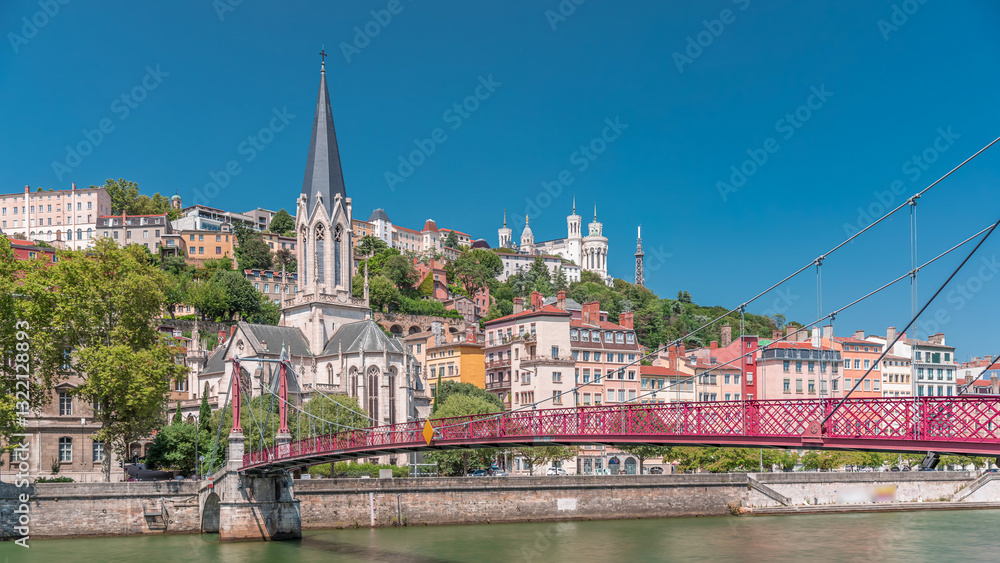 Obraz premium Timelapse hyperlapse of Saint George Church, Quais de Saone, and Fourviere Basilica from a footbridge in Vieux Lyon, France