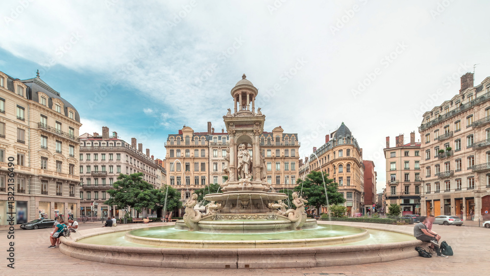 Fototapeta premium Hyperlapse of Place des Jacobins in Lyon, France, featuring the ornate Fontaine des Jacobins surrounded by historic buildings.