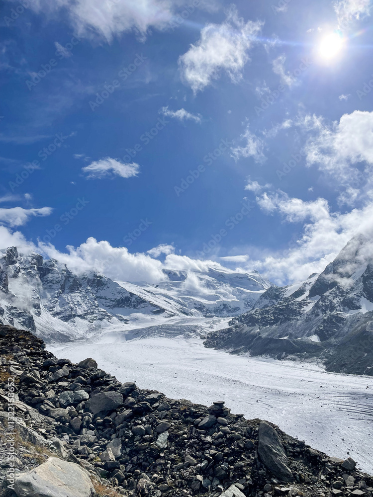 mountain landscape with clouds and snow. We can see a glacier in the background. Swiss Alps