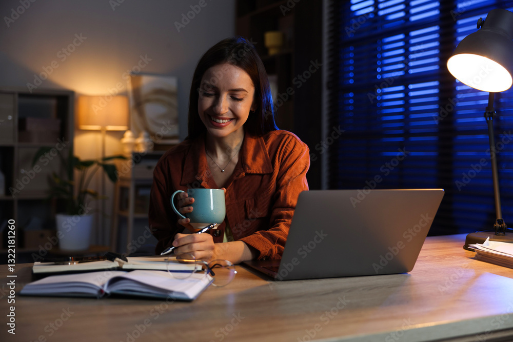 Woman taking notes while working at desk in home office