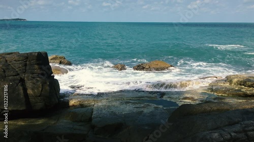 Water foams from impacts on rocks off the coast of the Gulf of Thailand