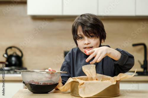 Mother and son are preparing a cherry cake together