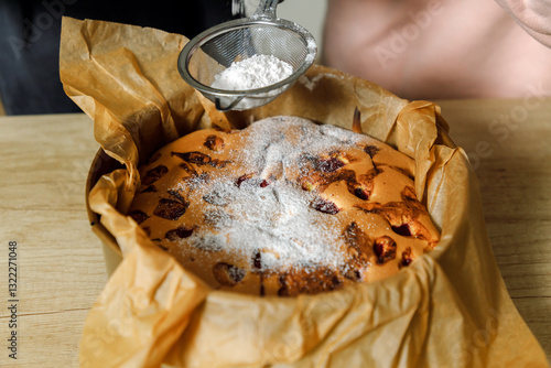 Mother and son are preparing a cherry cake together