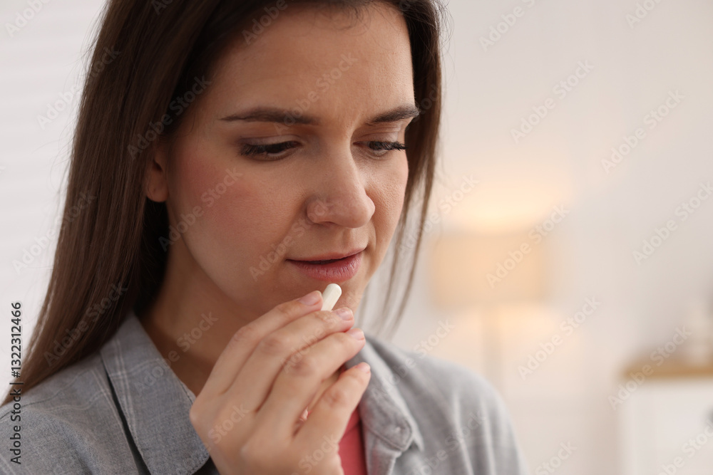 Woman taking medical pill at home, space for text Woman taking medical pill at home, space for text