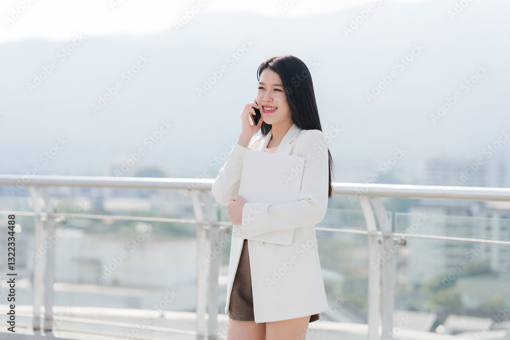 Smiling Asian Businesswoman Talking on Phone Outdoors Smiling Asian Businesswoman Talking on Phone Outdoors