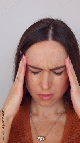 Wallpaper Mural Unwell Caucasian middle aged woman suffering from headache or migraine on white background. Concept of a health problems and grief. Vertical video. Torontodigital.ca