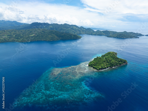 Schilderij op canvas A beautiful island is surrounded by a healthy coral reef off the coast of North Sulawesi, Indonesia