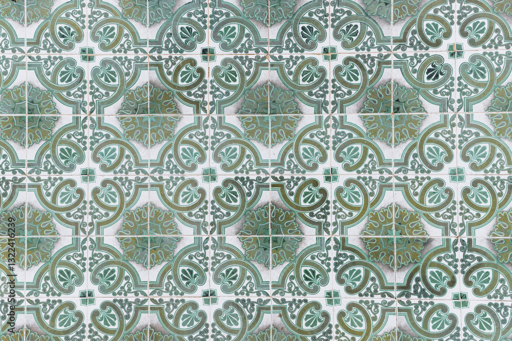 Traditional decorative tiles with ornate green and white patterns in a repeating design. Traditional decorative tiles with ornate green and white patterns in a repeating design.