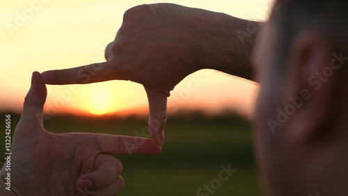 man stands serene field, capturing perfect sunset shot, capturing the perfect sunset, photographer perspective, golden hour magic, framing moment, chasing light, through lens, visual storytelling tips