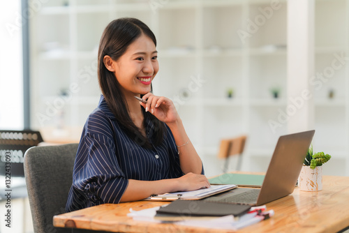 Smiling Asian Woman Working at Desk