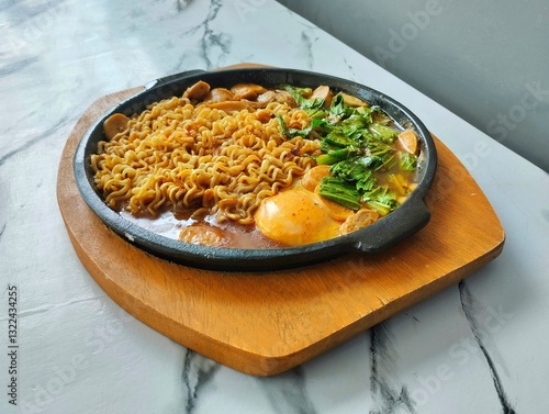 Hot Noodles with Egg and Vegetables on a hot plate