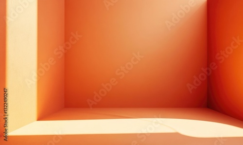 A room with a wall painted orange and a window letting in light