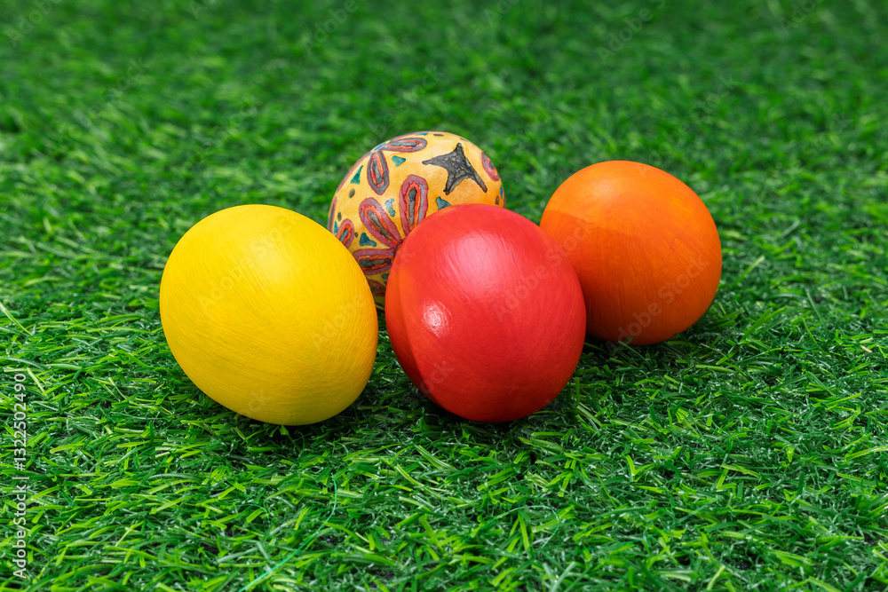Colorful Painted Easter Eggs on Green Artificial Grass with Blue Background Colorful Painted Easter Eggs on Green Artificial Grass with Blue Background