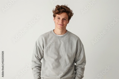 Wallpaper Mural Young man in oversized sweatshirt, isolated on gray background Torontodigital.ca