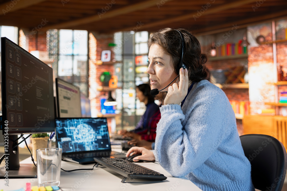 Fototapeta premium Call center worker wearing audio headset in office using AI to generate call scripts during conversation with customers. Woman doing customer support job using AI to summarize clients issues