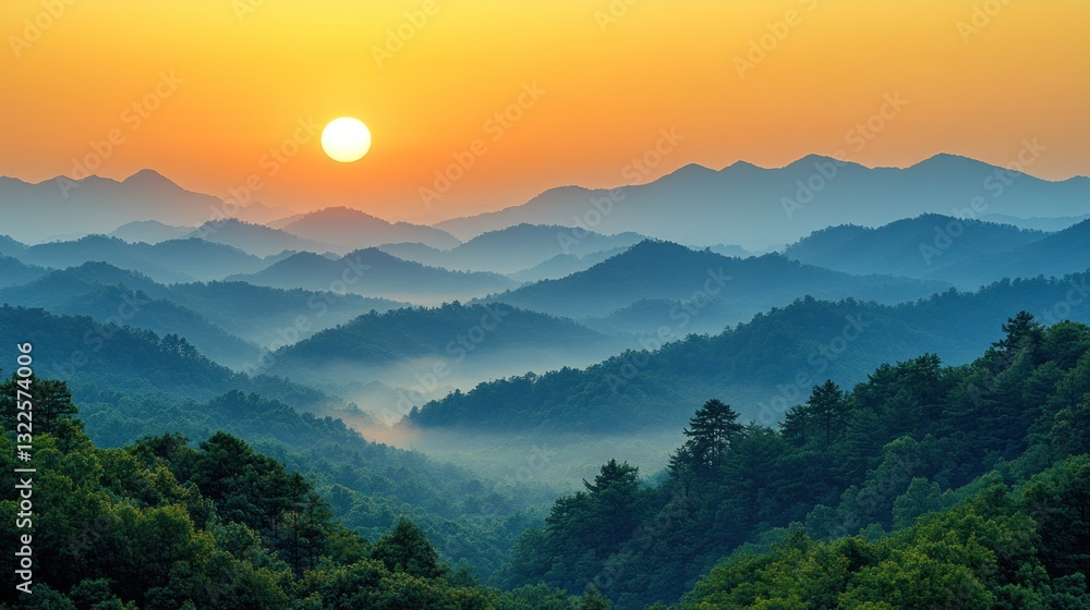 Obraz premium Majestic sunrise over misty mountain ranges.