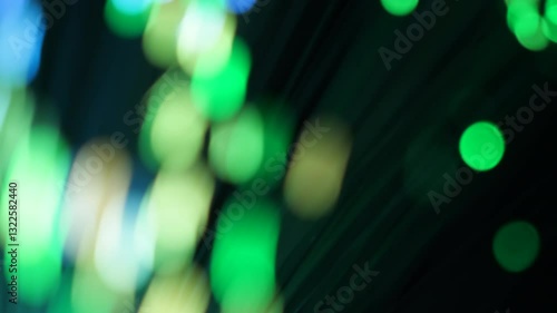 Energetic abstract composition features streaks of neon green light flowing dynamically over a deep black background, creating a sense of swift movement.