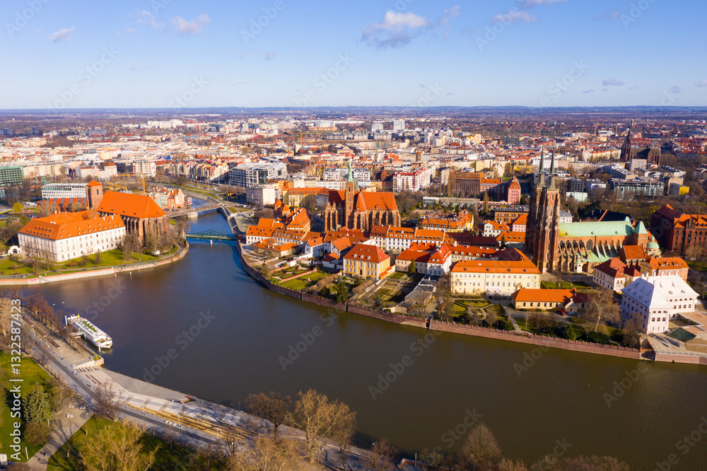 Fototapeta premium Scenic view from drone of Gothic buildings of Cathedral of St. John Baptist and Collegiate Church of Holy Cross and St. Bartholomew on Ostrow Tumski on sunny day, Wroclaw, Poland..