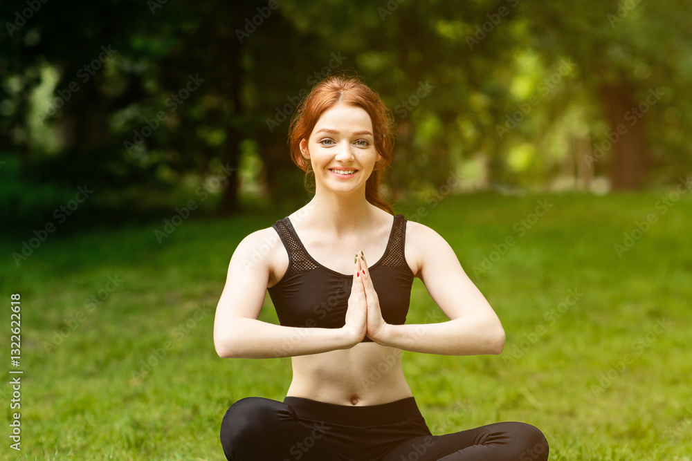 Cheerful Caucasian woman making namaste gesture during her outdoor yoga meditation. Panorama Cheerful Caucasian woman making namaste gesture during her outdoor yoga meditation. Panorama