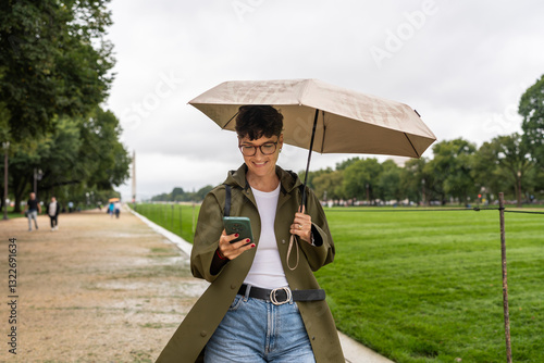 Tourist using smartphone and holding umbrella in Washington D.C