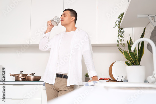 Handsome young man drinking...