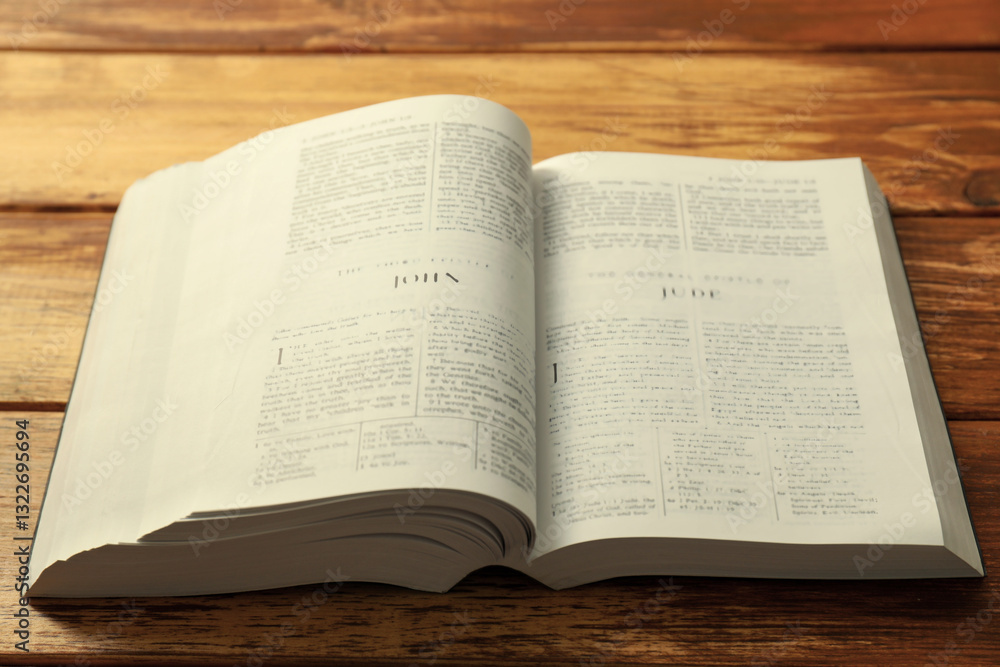 Open Holy Bible in English language on wooden table, closeup Open Holy Bible in English language on wooden table, closeup
