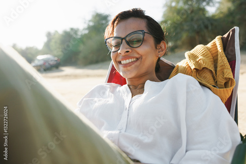 A cheerful woman in a foldable chair in the desert