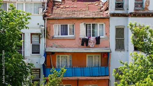 old house in the village with windows hanging laundry outside