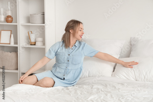 Pretty young woman lying on...