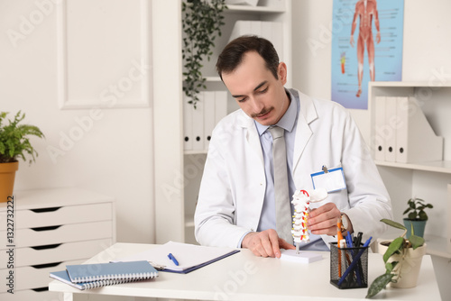 Male doctor with spine mode...