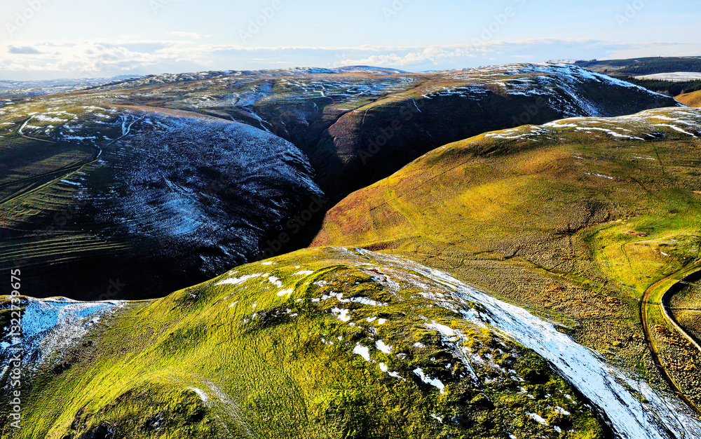 Castle Hills prehistoric hillfort, Alwinton, Northumberland. NW over contoured ramparts to Cheviot Hills. Clennell Street ancient drove road on right