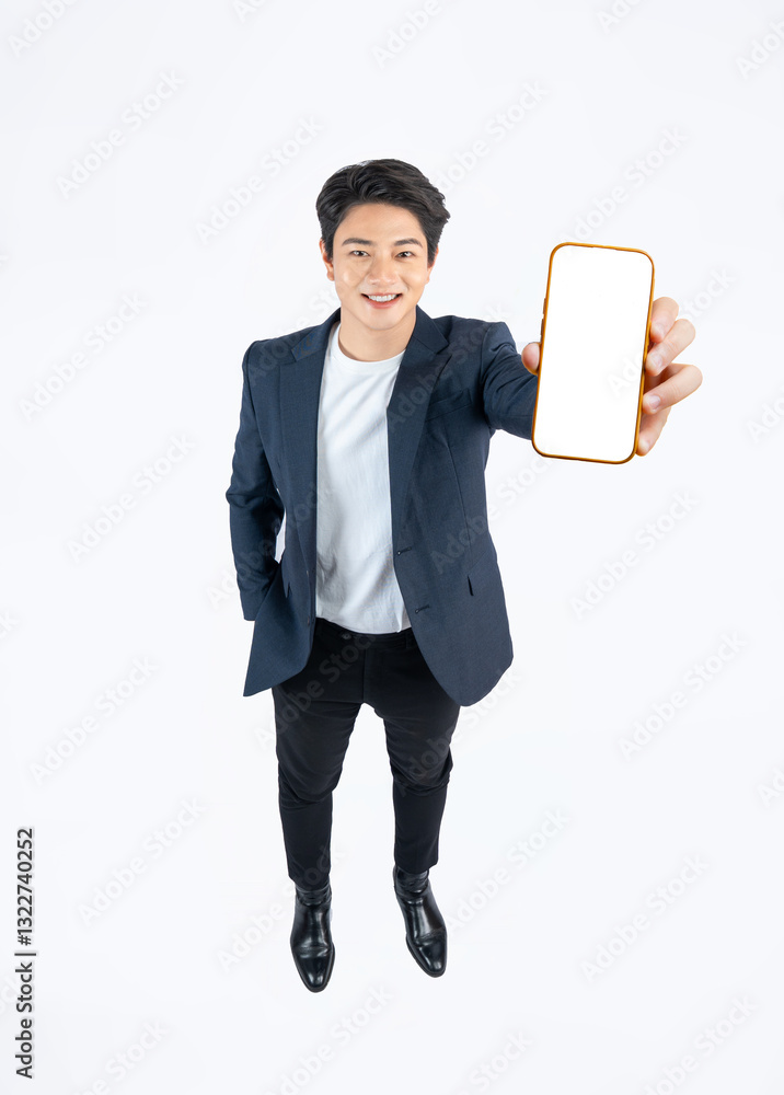 Full body image of a young Asian business man posing top view and using phone on a white background Full body image of a young Asian business man posing top view and using phone on a white background