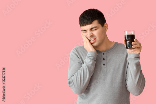 Young man with glass of sod...