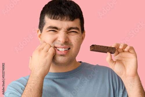 Young man with candy bar su...